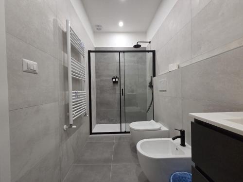 a bathroom with a shower and a toilet and a sink at Mammarusina in Brindisi