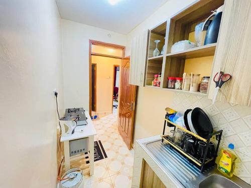 a kitchen with a sink and a counter top at Modern & Cozy 1 Bedroom BnB in Nyeri in Nyeri