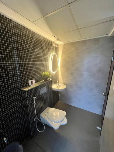 a bathroom with a toilet and a sink at Havens home in Mangrul