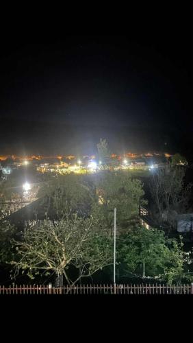 a view of a city at night with lights at SWISS Apartment in Pokoj