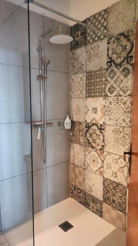 a shower with a glass door in a bathroom at Guesthouse Las Hamacas Abruzzo in Pianella