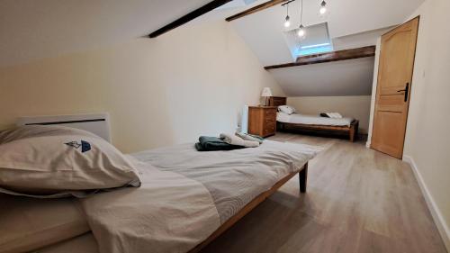 a bedroom with a large bed in a room at Les Bigoussies 1 Gite Vert in Saint-Méard-de-Dronne