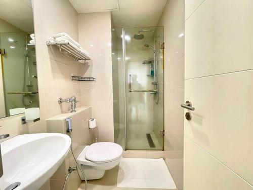 a bathroom with a shower and a toilet and a sink at Luxury Cozy Apartment - Fairway Galle in Galle
