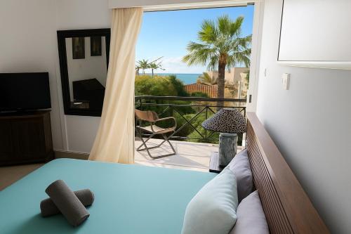 a bedroom with a bed and a view of the ocean at Sea view Beach House with Pool in Limassol