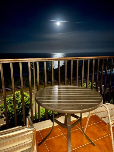 a table on a balcony with a view of the ocean at Taitung Blue Sea Villa in Chenggong