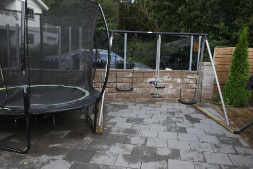 a bath tub in a yard with a glass wall at Between the Trees in Gothenburg