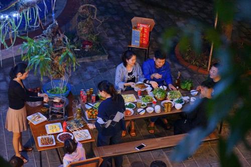a group of people standing around a table with food at Ninh Binh Kong's Homestay in Nguyên Ngoại