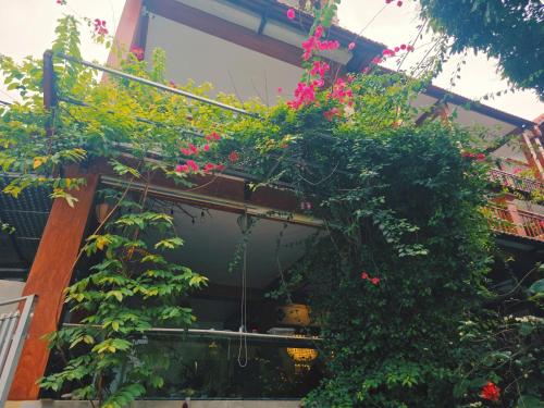 a balcony with pink flowers and plants on it at Ninh Binh Kong's Homestay in Nguyên Ngoại