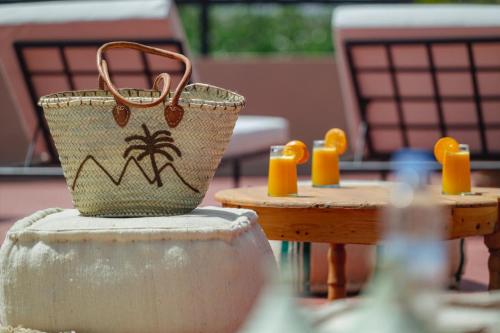 a basket sitting on top of a table next to a table at Le mas de l'Ourika, maison d'hôtes in Aït Zat