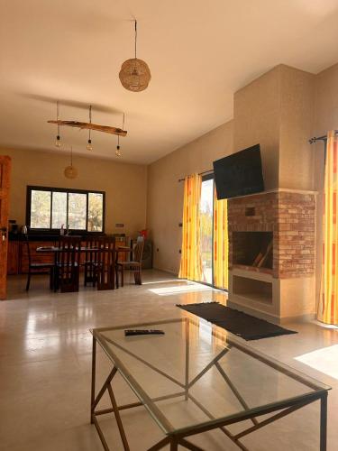 a living room with a fireplace and a dining room at Dar essafae in Essaouira