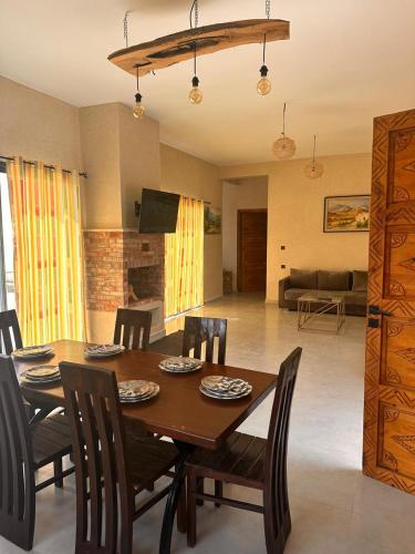 a dining room table and chairs in a living room at Dar essafae in Essaouira