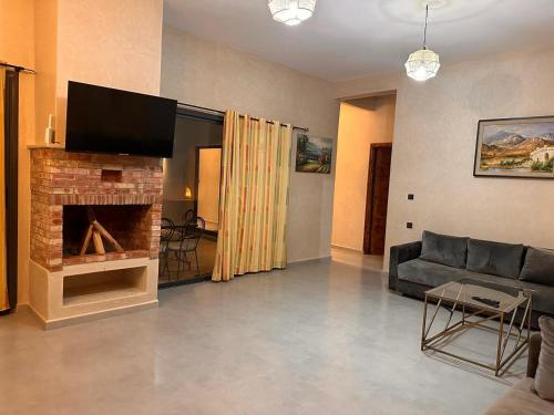 a living room with a couch and a fireplace at Dar essafae in Essaouira