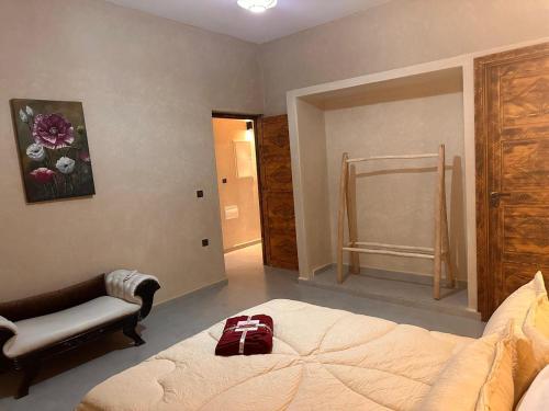 a bedroom with a bed and a chair in it at Dar essafae in Essaouira