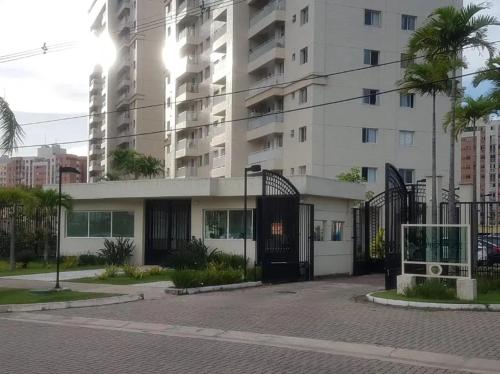 a building with a black gate in a city at COP 30 Apartamento Luxo - 3 Quartos, Piscina, Academia, Area de Lazer in Belém