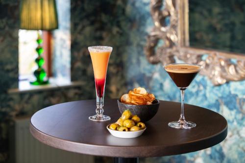 two cocktails and a bowl of food on a table at Morley Hayes Hotel in Derby