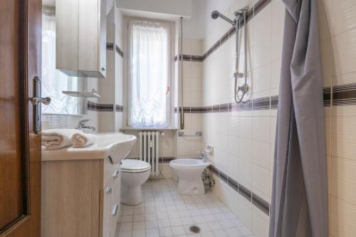 a white bathroom with a toilet and a sink at Vintage al passetto - Ancona Centro in Ancona