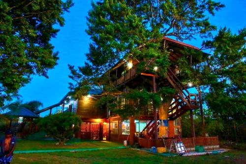 a tree house with a staircase up to it at Lake Wind Resort & Restaurant in Polgahawelana