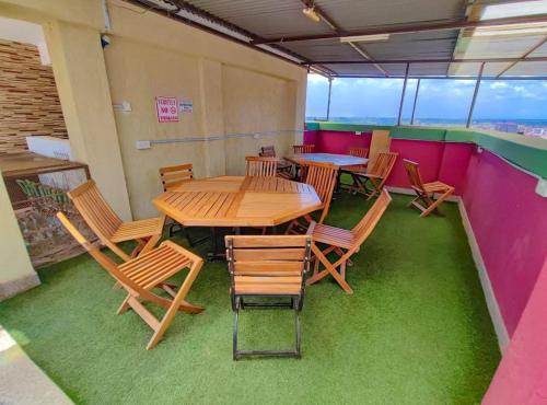 a table and chairs in a room with greengrass at Valley View Residence in Ruiru