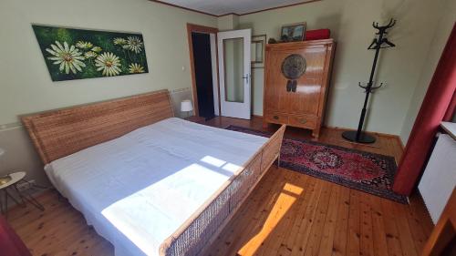 a bedroom with a large bed and a dresser at ein hübsches Fleckchen Erde/ a lovely spot in Veitshöchheim