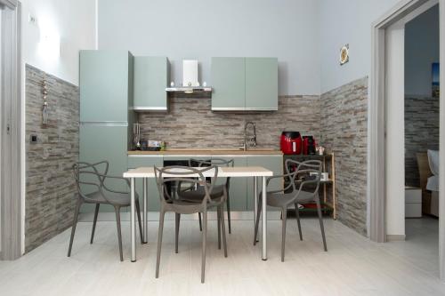a kitchen with a table and chairs in a room at Punta mare in Marsala