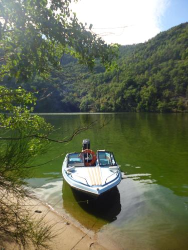 a small boat in the water on a lake at T1 Cosy "Clairefont" Terrasse privée vue Loire dans Maison in Aurec-sur-Loire