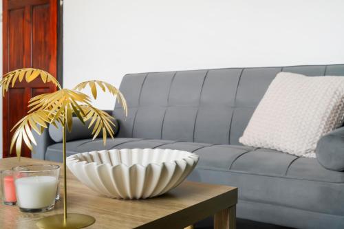 a living room with a couch and a table with a bowl at 2 King 4 Singles 2 Sofa Beds Driveway Parking x 3 Private Garden Decking in Hillingdon