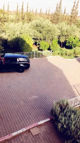 a black car parked in a parking lot at Hotel Family Park in Marrakech
