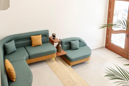 a living room with two chairs and a couch at The MONT BOUTIQUE HOTEL in Shkodër