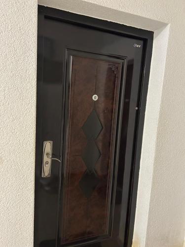 a wooden door with a handle on a wall at Relax in Tetovo