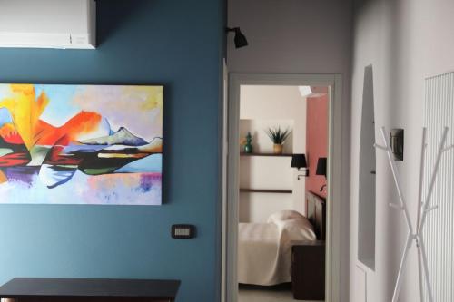 a blue room with a painting on the wall at La Corte dei Mercanti by Stresahome - Centro Storico in Stresa