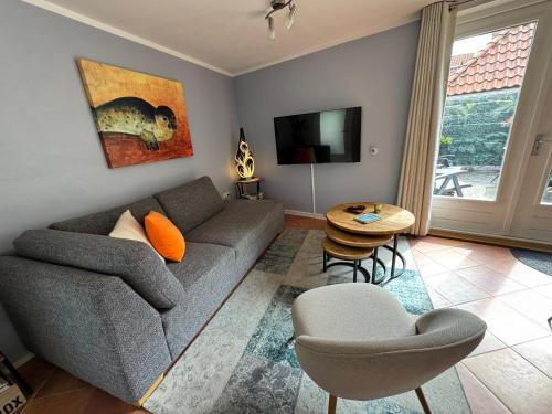 a living room with a couch and a table at Balsemientexel in De Koog