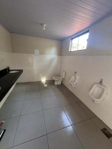 a bathroom with two urinals and two toilets at Chacara the fest is an ideal place to relax in Uberlândia