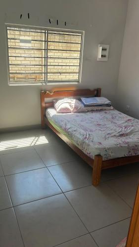 a bedroom with a bed and a window in a room at Chacara the fest is an ideal place to relax in Uberlândia