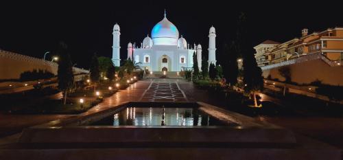 a mosque at night with a fountain in front at Porto Sharm Retreat by Mraky Rentals in Sharm El Sheikh