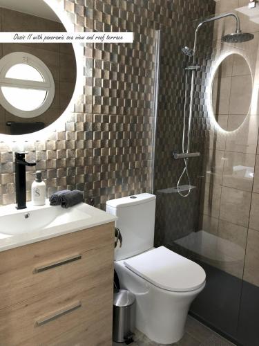 a bathroom with a toilet and a sink and a shower at Villa Oasis Costa Brava in Lloret de Mar