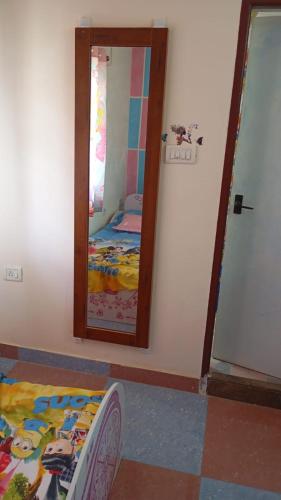a bedroom with a mirror and a bed in it at Abi Homestay - with Luxury feel at Guduvanchery 
