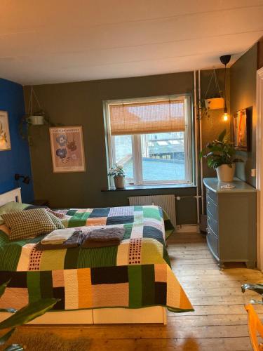 a bedroom with a bed with a colorful quilt at Central Aalborg Cozy and Quiet in Aalborg