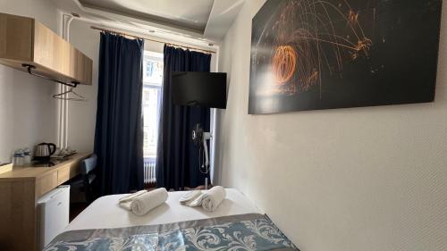 a hotel room with a bed with towels on it at hotel whiteswan in Ehnen
