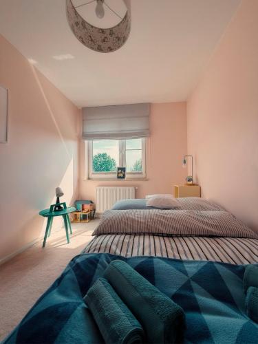 a bedroom with a large bed and a window at Apartament Wysockiego in Bielsk Podlaski