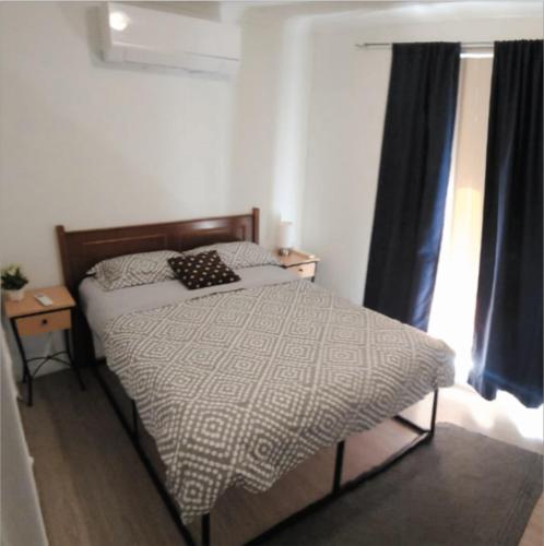 a small bedroom with a bed and a window at Airport budget room in Perth
