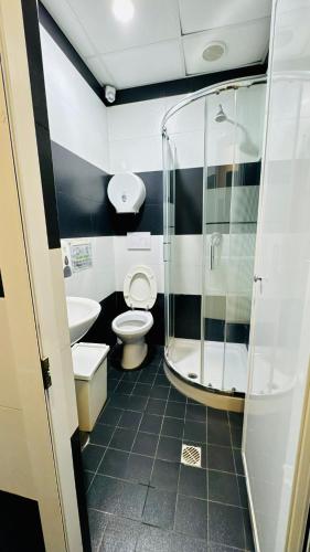 a bathroom with a shower and a toilet and a sink at Star City Guest House in Rome