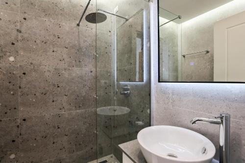 a bathroom with a glass shower and a sink at The MONT BOUTIQUE HOTEL in Shkodër