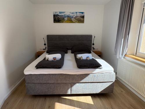 a bed with two pillows on it in a bedroom at Oetztal Auszeit Top 7 in Umhausen