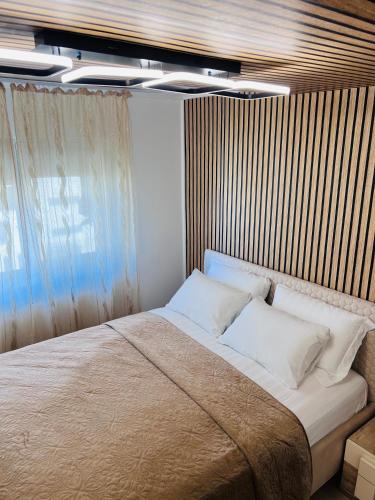 a bedroom with a large bed with white pillows at Imperium DK Apartament in Giurgiu