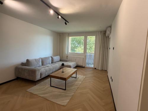 a living room with a couch and a table at Moderno stanovanje - Ptuj in Ptuj