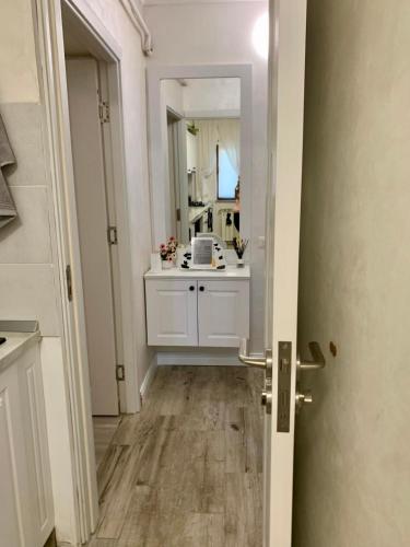 a bathroom with a sink and a mirror at Central and beautiful flat in Focşani