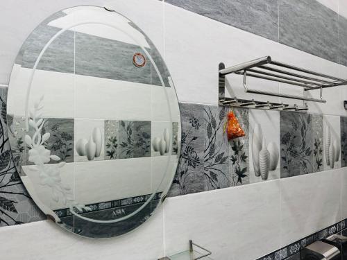 a mirror on the wall of a bathroom at Kha Phat Central Dalat with Local Charm in Xuan An