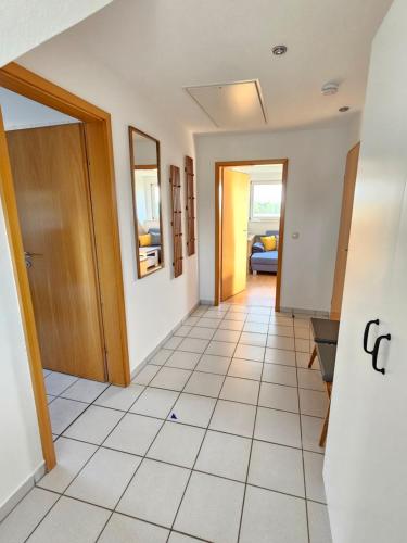 a hallway with a door and a tile floor at Ferienwohnung Meerzeit in Großenbrode