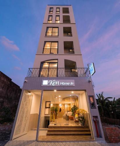 a tall building with a sign that reads korean home inn at Ken Home In in Long Trường
