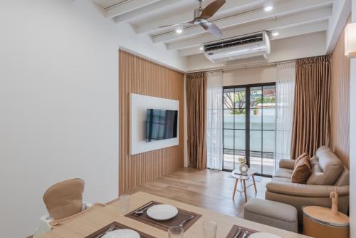 a living room with a couch and a table at The Urban478 Modern&Cozy Stay in Bangkok